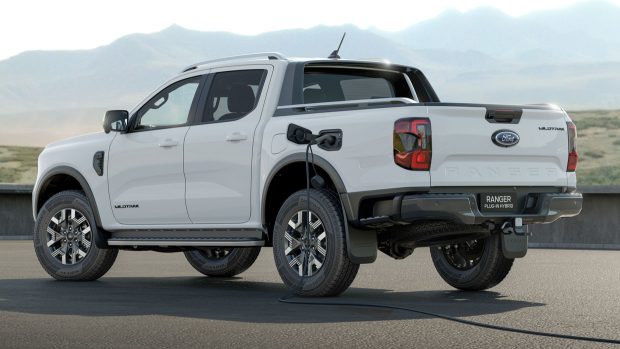 A Ford Ranger Wildtrak plug-in hybrid ute with a charging cable plugged in to its charge port