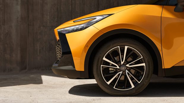 Yellow and murky 2023 Toyota C-HR shrimp SUV, entrance wheel stop-up