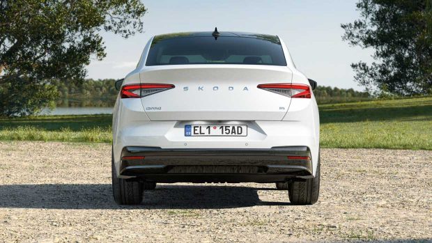 A 2024 Skoda Enyaq painted in white with the record exhibiting the fleshy rear pause of the coupe model