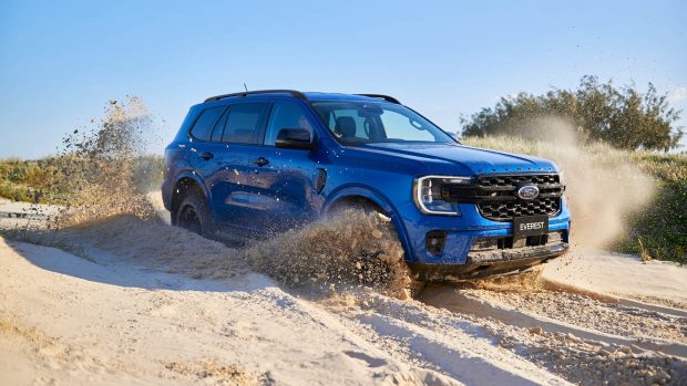 2024 Ford Everest Sport blue front 3/4 driving by comfy sand