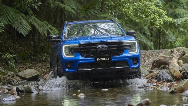 2024 Ford Everest Sport blue driving by rocky creek