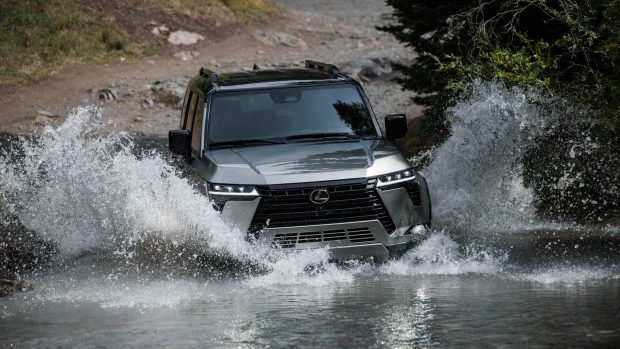 2024 Lexus GX front perspective riding shot thru water